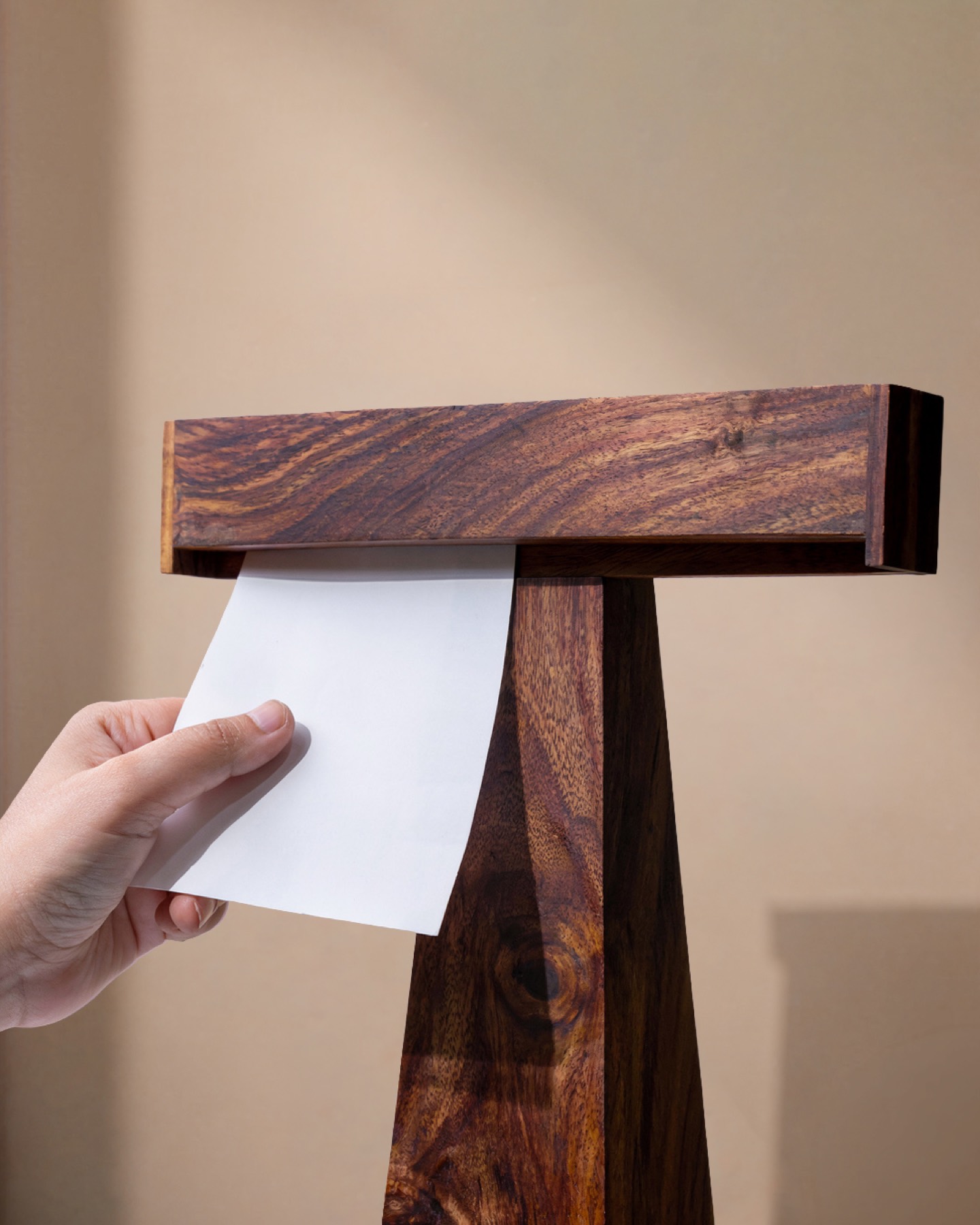 A hand sliding a note into the precision slot