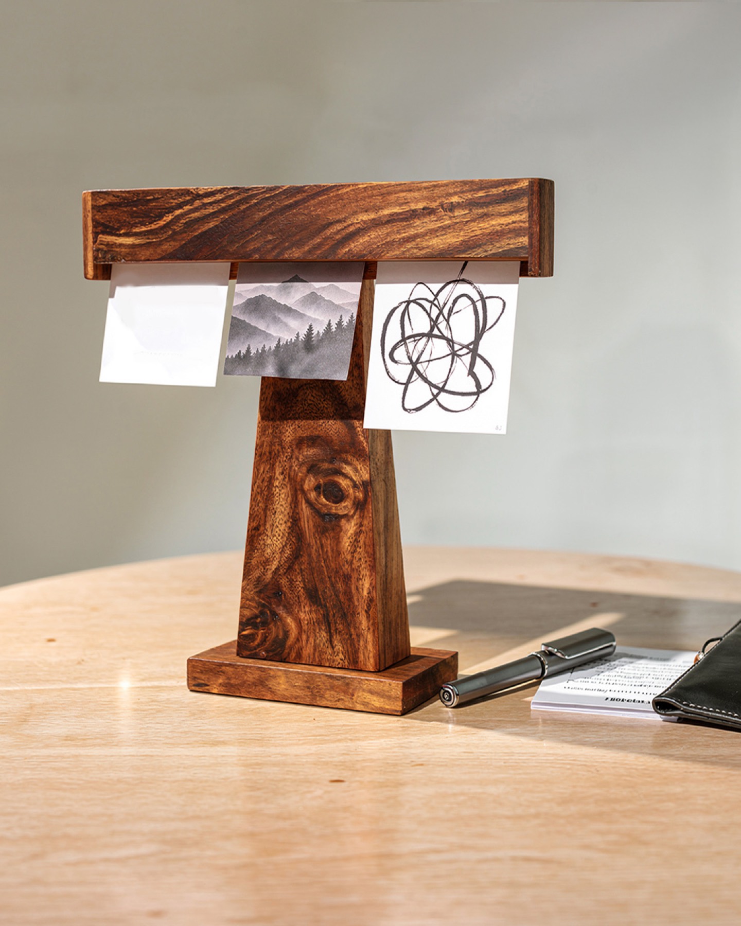 Display Dock holding art prints beside a fountain pen