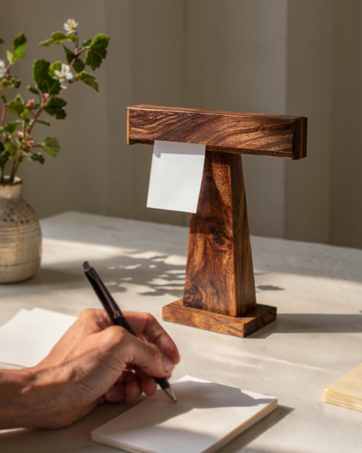 A hand writing a note beside the Display Dock