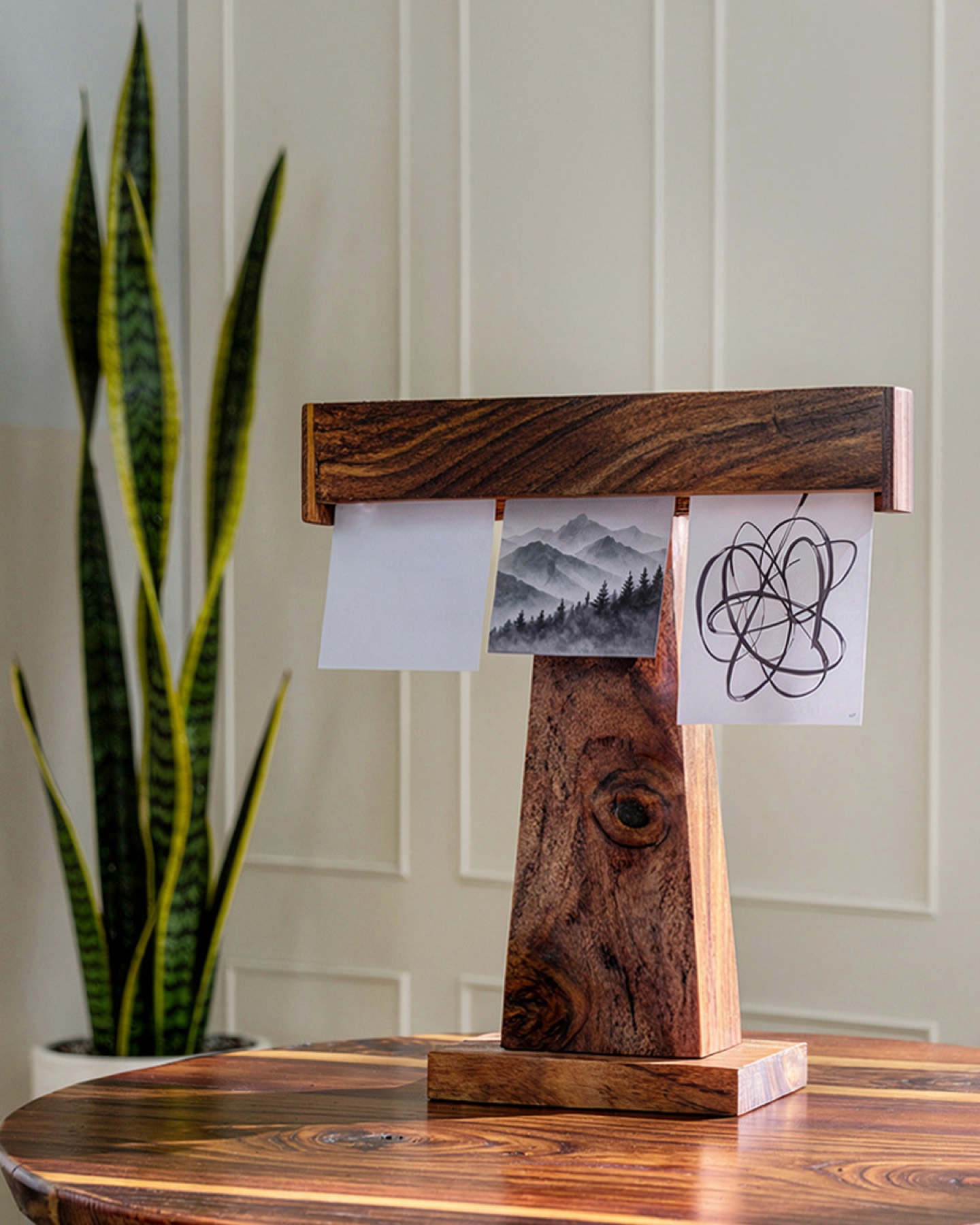 Display Dock holding art cards on a polished wood table